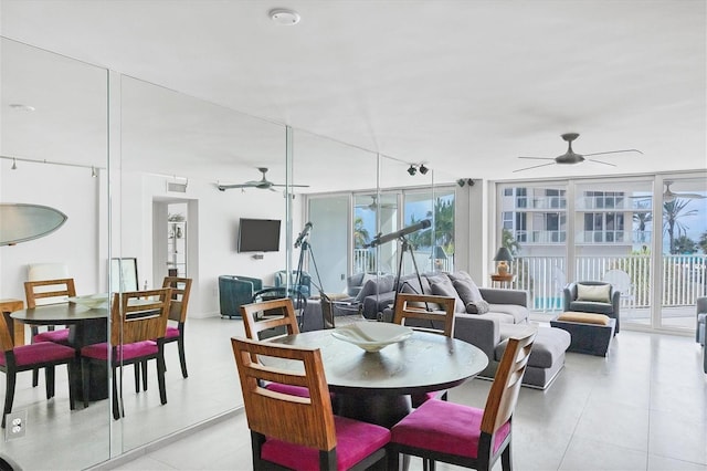 dining area with ceiling fan and expansive windows