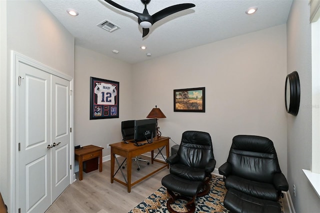 office featuring ceiling fan, a textured ceiling, and light hardwood / wood-style floors