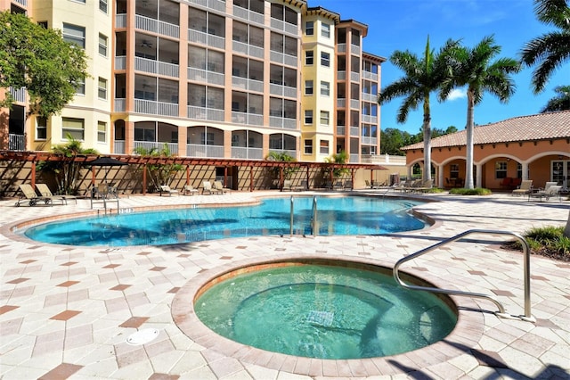 view of pool featuring a hot tub and a patio area