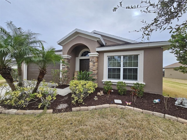 view of front of house with a front lawn and a garage