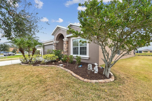 view of front of property with a front lawn and a garage