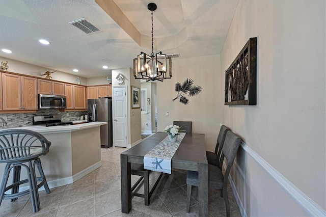 dining area featuring light tile patterned flooring, recessed lighting, visible vents, and a textured ceiling