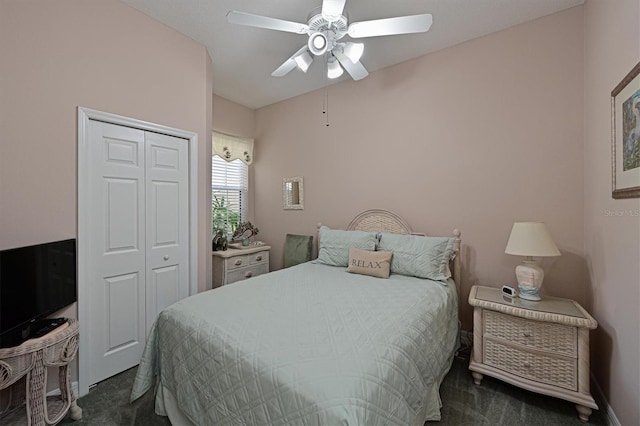 bedroom featuring ceiling fan, a closet, and dark colored carpet