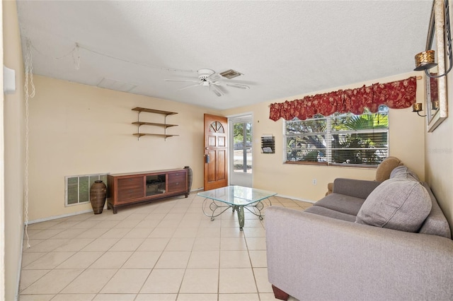 tiled living room with a textured ceiling, a wealth of natural light, and ceiling fan