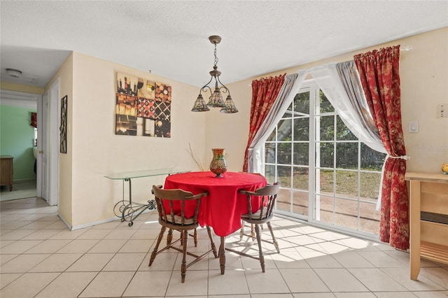 tiled dining area featuring a textured ceiling