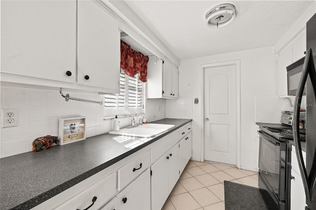 kitchen with sink, white cabinetry, a textured ceiling, light tile patterned floors, and black appliances