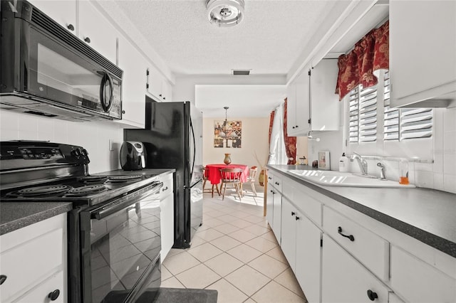 kitchen with sink, light tile patterned floors, backsplash, black appliances, and white cabinets