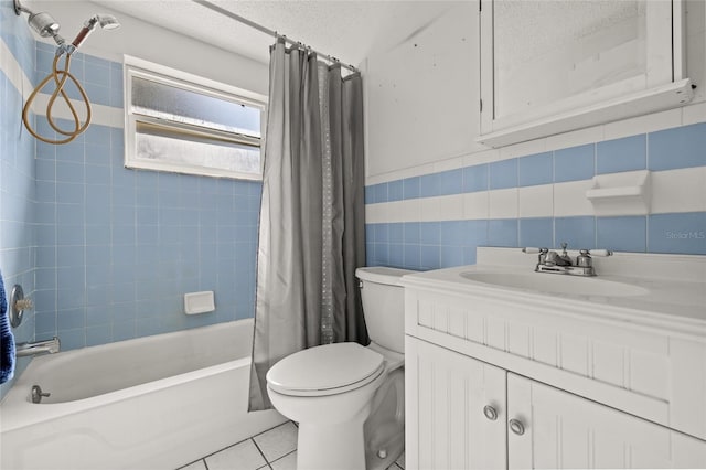 full bathroom with shower / tub combo with curtain, tile patterned floors, toilet, a textured ceiling, and tile walls