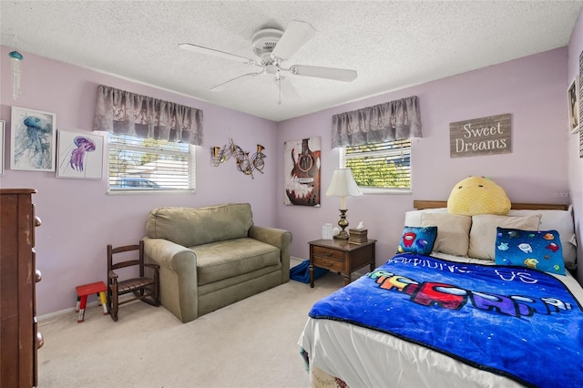 carpeted bedroom featuring multiple windows, ceiling fan, and a textured ceiling