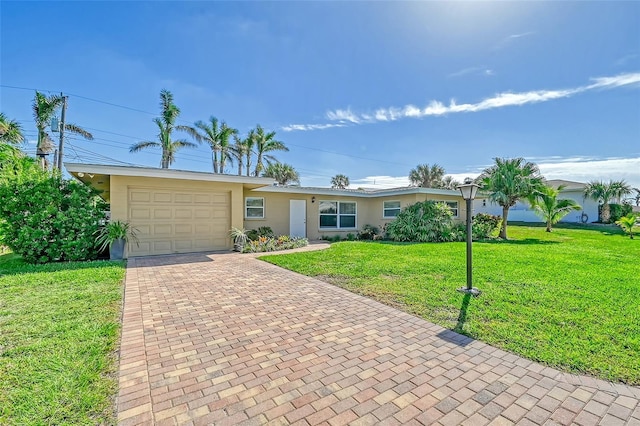 ranch-style house featuring a front yard and a garage