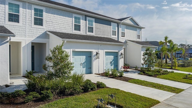 view of front facade with a front yard and a garage