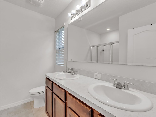 bathroom with toilet, tile patterned flooring, walk in shower, and vanity