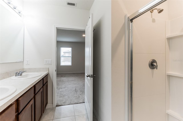 bathroom with vanity, tile patterned flooring, and walk in shower