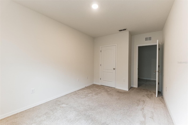 unfurnished bedroom with light colored carpet