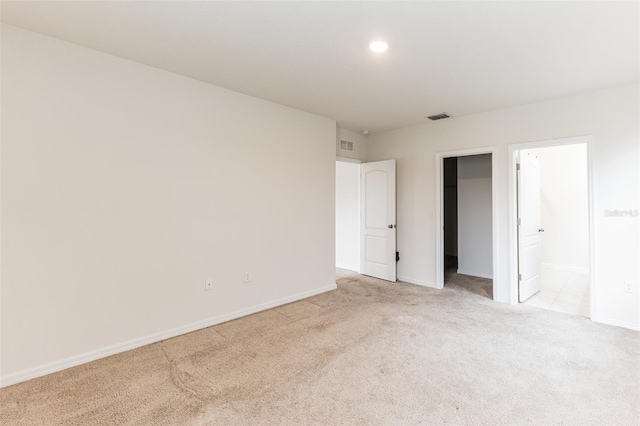 spare room featuring light colored carpet