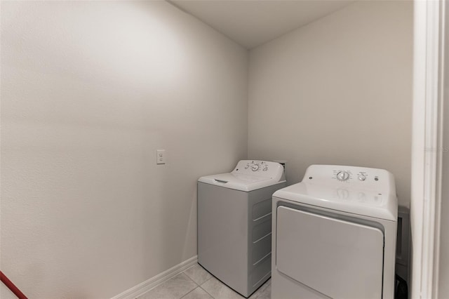 laundry room featuring washer and dryer and light tile patterned floors