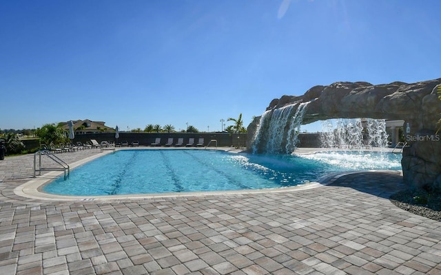 view of pool with pool water feature