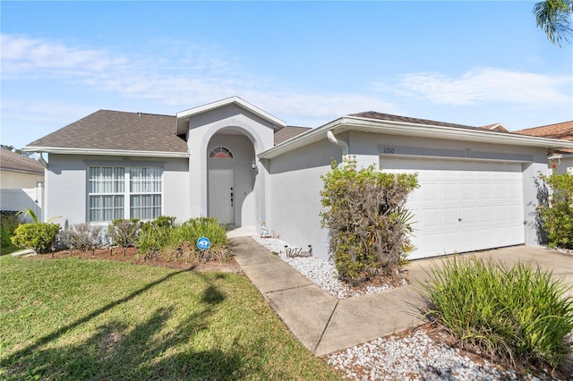 ranch-style home featuring a garage and a front lawn