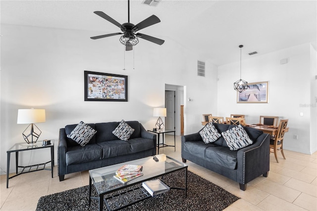 tiled living room featuring ceiling fan and high vaulted ceiling