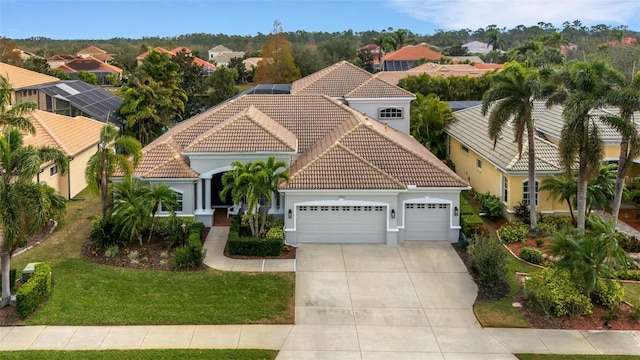 mediterranean / spanish house featuring a garage and a front yard