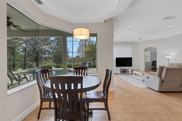 dining room featuring ceiling fan, plenty of natural light, and light tile patterned flooring