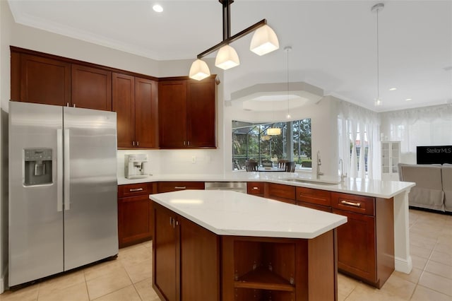 kitchen with pendant lighting, appliances with stainless steel finishes, a kitchen island, sink, and light stone counters