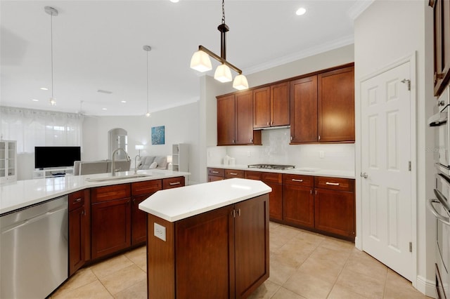 kitchen with a center island, stainless steel appliances, decorative backsplash, sink, and hanging light fixtures