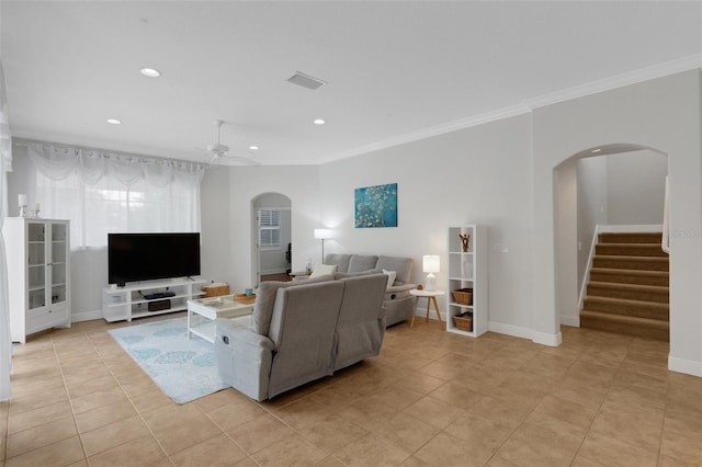 tiled living room featuring ceiling fan and ornamental molding