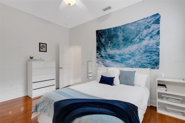 bedroom with ceiling fan and hardwood / wood-style flooring