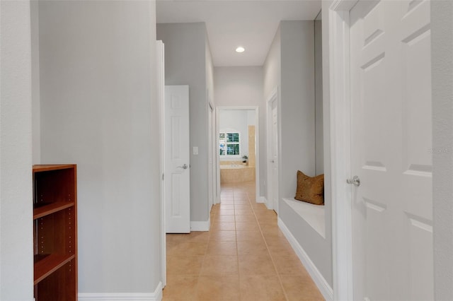 corridor with light tile patterned flooring