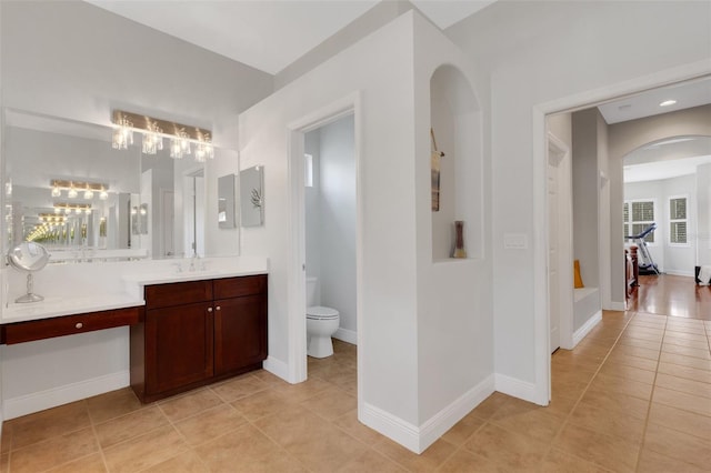 bathroom featuring toilet, tile patterned floors, and vanity