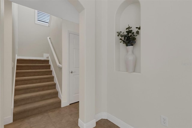 stairs featuring tile patterned flooring