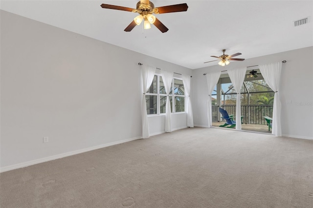 spare room featuring light carpet and ceiling fan