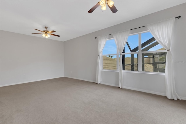 empty room with ceiling fan and carpet flooring