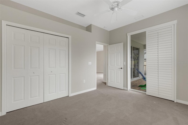 unfurnished bedroom featuring ceiling fan, a closet, and light colored carpet