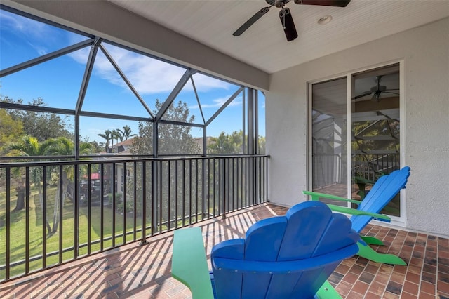 view of patio / terrace with ceiling fan and glass enclosure