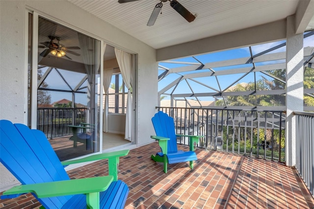 view of patio / terrace featuring glass enclosure and ceiling fan