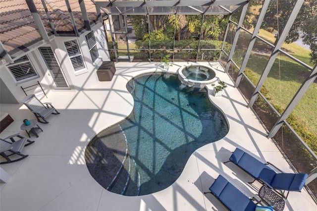 view of swimming pool with glass enclosure, a patio area, and an in ground hot tub