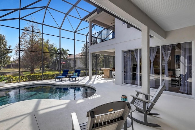 view of pool with a patio area, a lanai, and ceiling fan