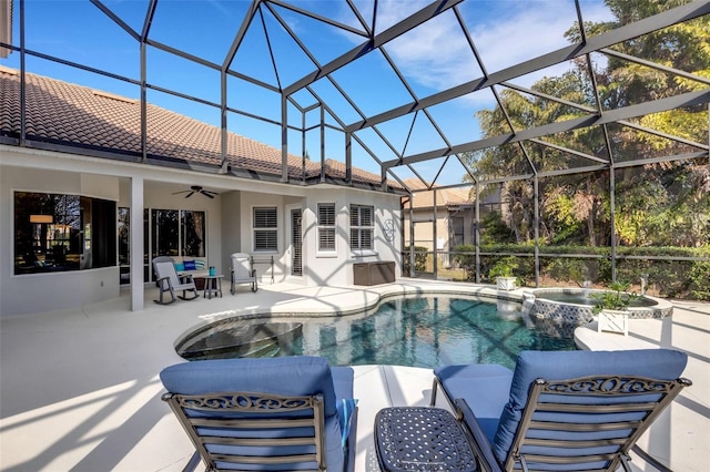 view of pool with ceiling fan, glass enclosure, an in ground hot tub, and a patio