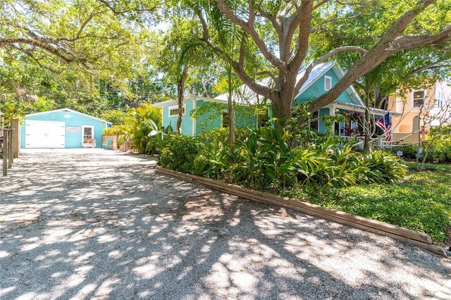 exterior space featuring a garage and an outbuilding