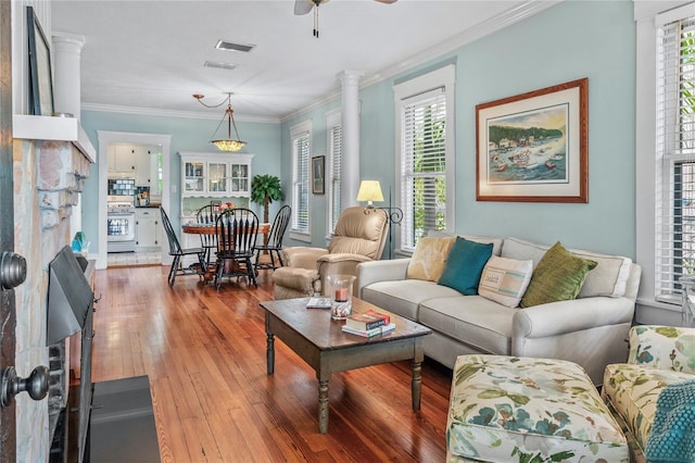 living room with ornamental molding, ceiling fan, and hardwood / wood-style floors