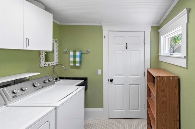 laundry area with cabinets, ornamental molding, separate washer and dryer, and sink