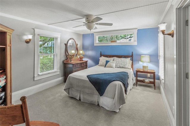 carpeted bedroom with ornamental molding, ceiling fan, and multiple windows