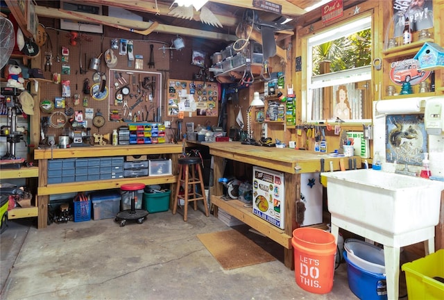 miscellaneous room featuring a workshop area and concrete floors