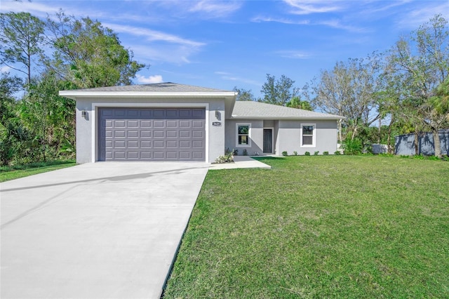 ranch-style house featuring a front yard and a garage