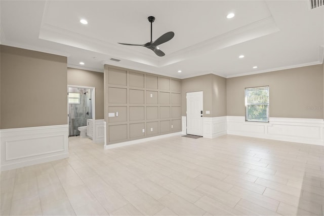 unfurnished room with ceiling fan, ornamental molding, and a tray ceiling