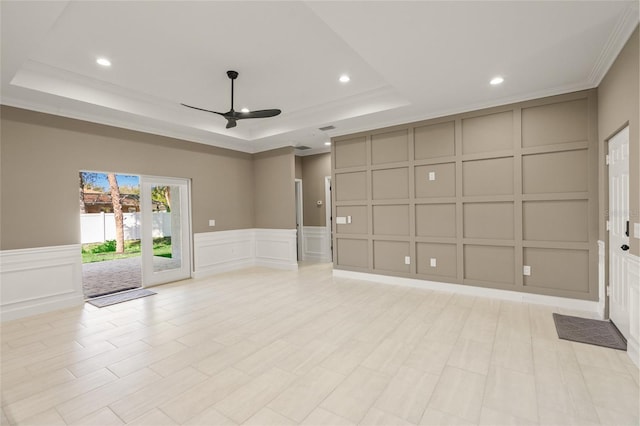 unfurnished room featuring ceiling fan, a tray ceiling, and ornamental molding