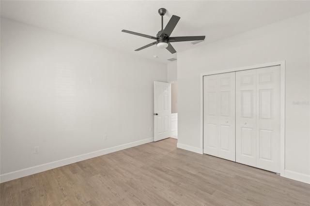 unfurnished bedroom featuring a closet, ceiling fan, and light hardwood / wood-style flooring