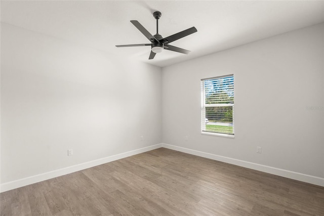 unfurnished room with ceiling fan and wood-type flooring